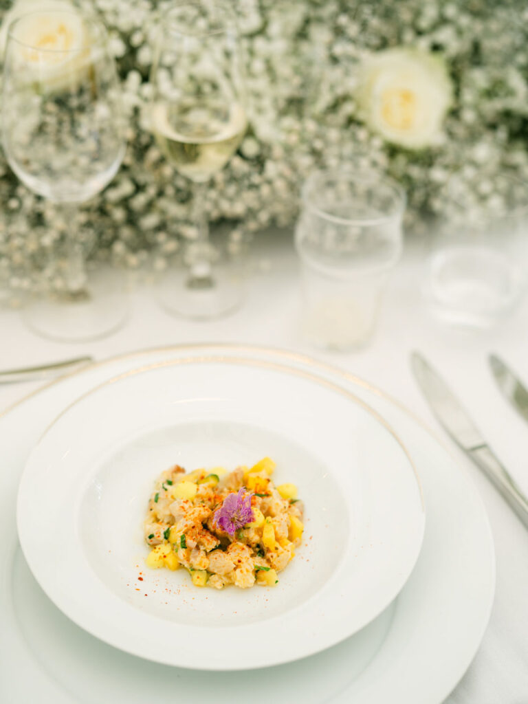 Beautifully plated dish of fresh seafood, paired with sparkling wine, served at Kevin and Steven's wedding