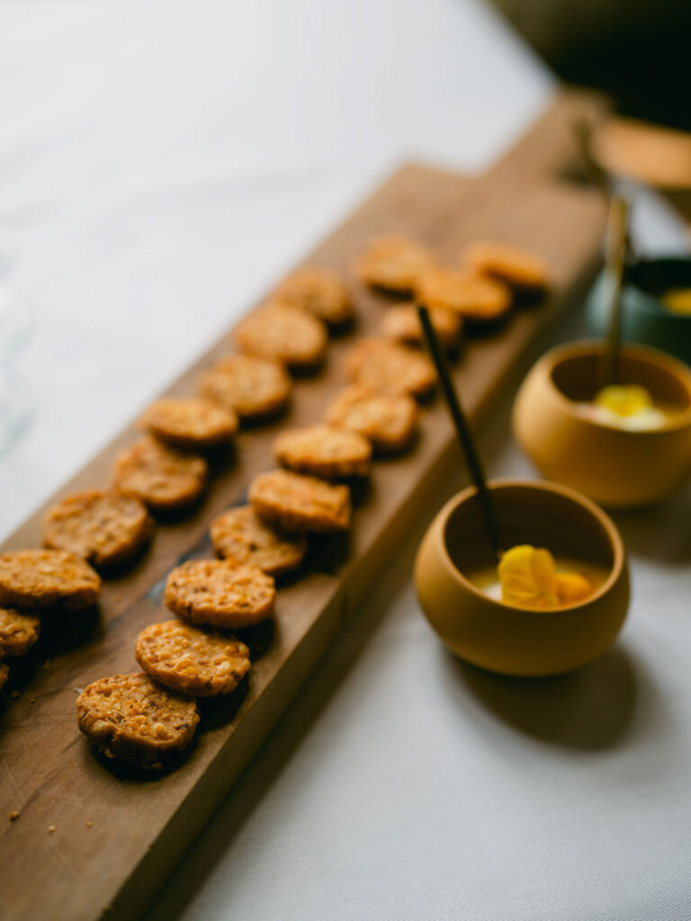 Selection of bite-sized savory pastries arranged on a wooden serving board