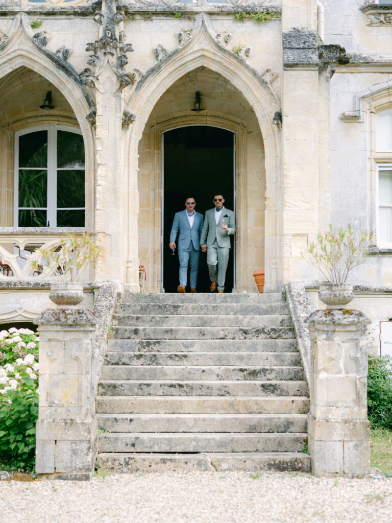 Kevin and Steven exit the elegant château as they prepare for their wedding ceremony in France