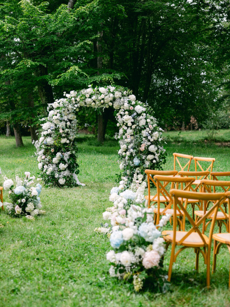 Beautiful floral arch and seating setup for Kevin and Steven's outdoor wedding in France