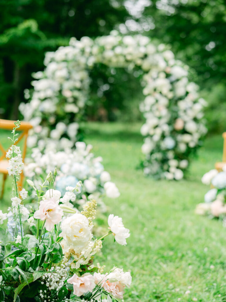 Elegant floral details line the aisle at Kevin and Steven's outdoor wedding in France