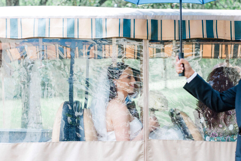 Bride seated under a protective cover on her wedding day