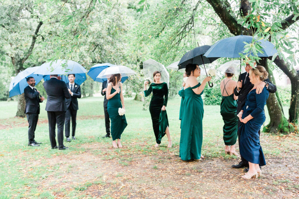 Wedding party under umbrellas on a rainy day