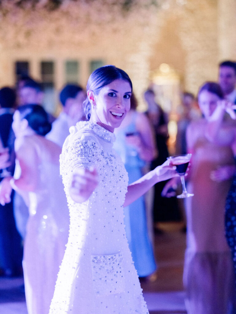 Alexandra, the bride celebrating on the dance floor in an embellished gown