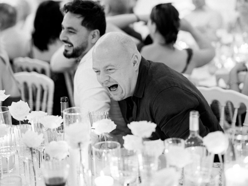 Wedding guest laughing joyfully during the reception