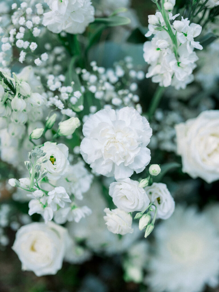 Close-up of delicate white florals in the wedding decor