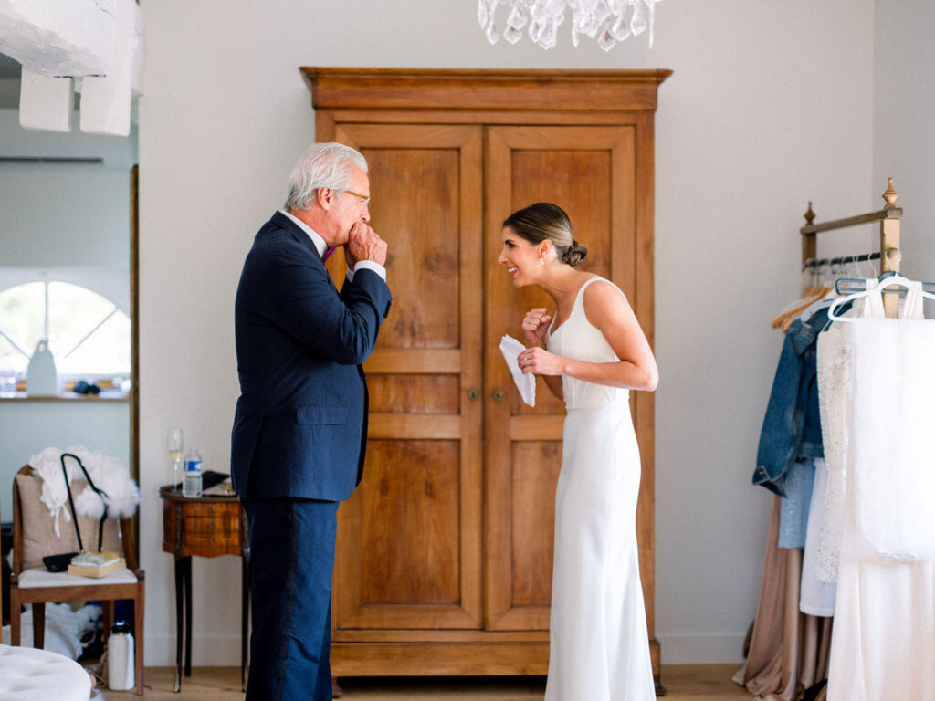 Bride and father share a heartfelt moment indoors