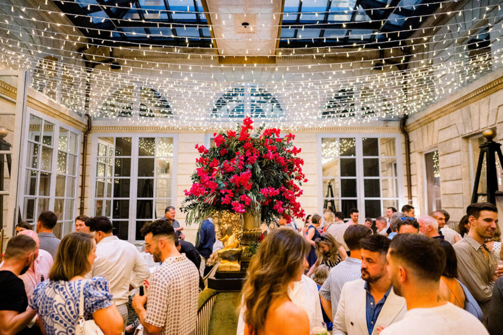 Guests enjoying a vibrant reception space adorned with floral arrangements