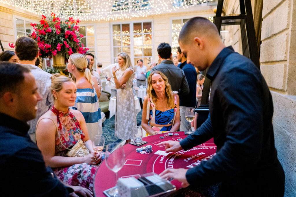 Guests playing at a poker table during the casino-themed reception