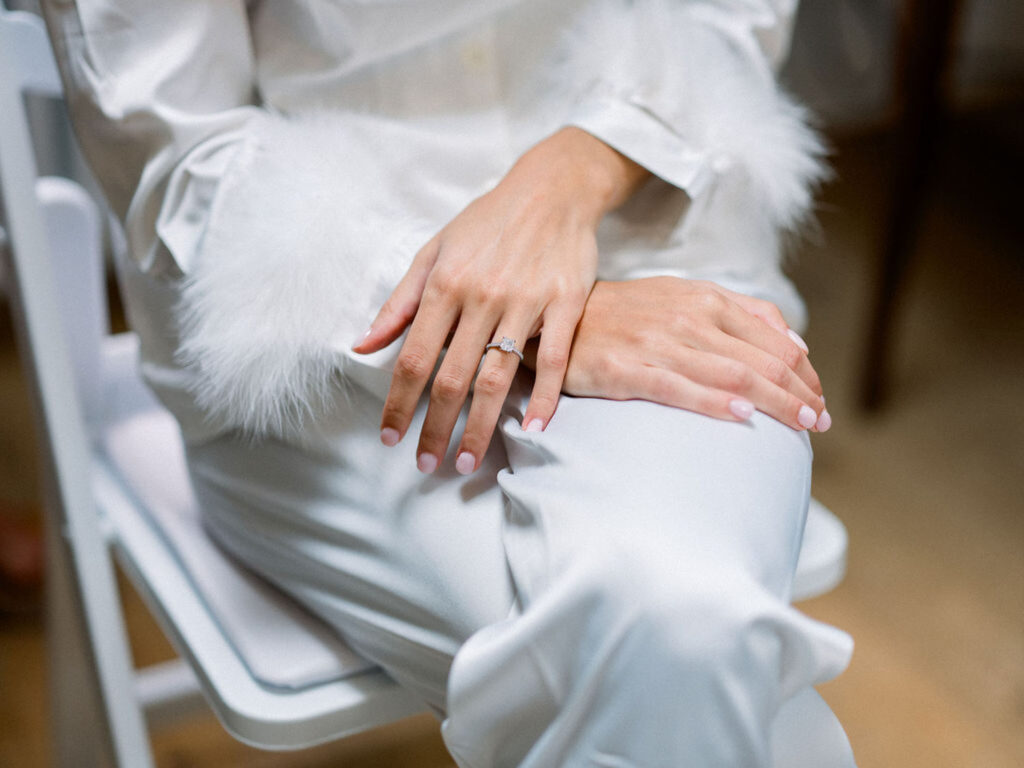 Close-up of the bride’s engagement ring on her hand