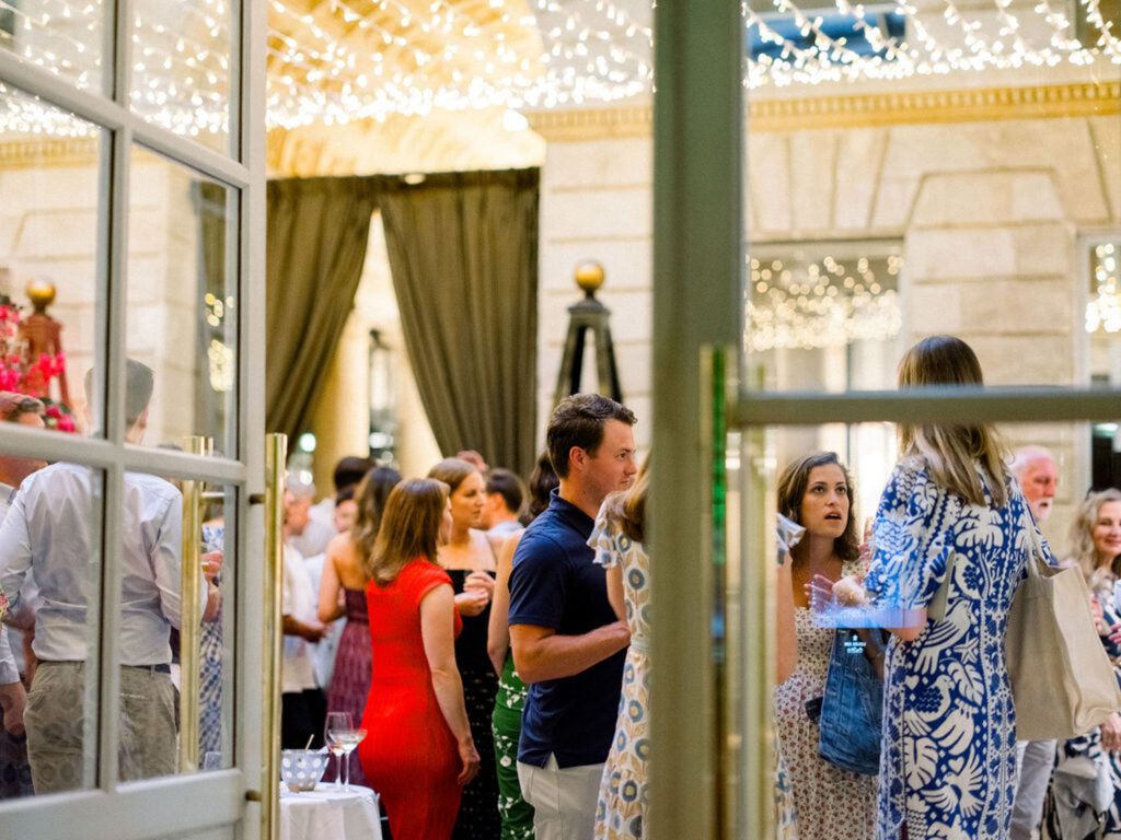 Guests mingling under string lights during cocktail hour