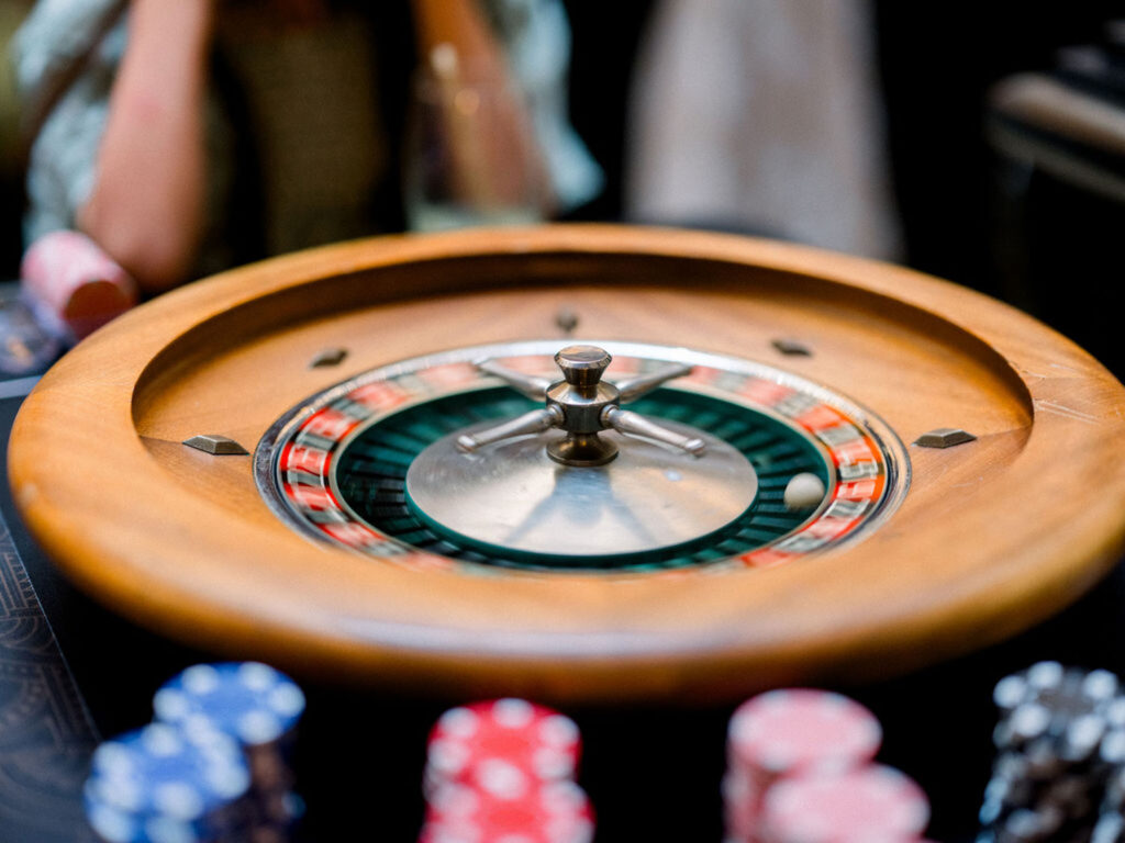 Roulette table with chips and a spinning wheel during cocktail hour