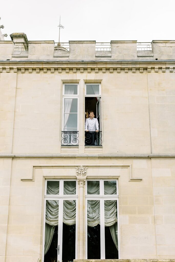 Man looking out from balcony