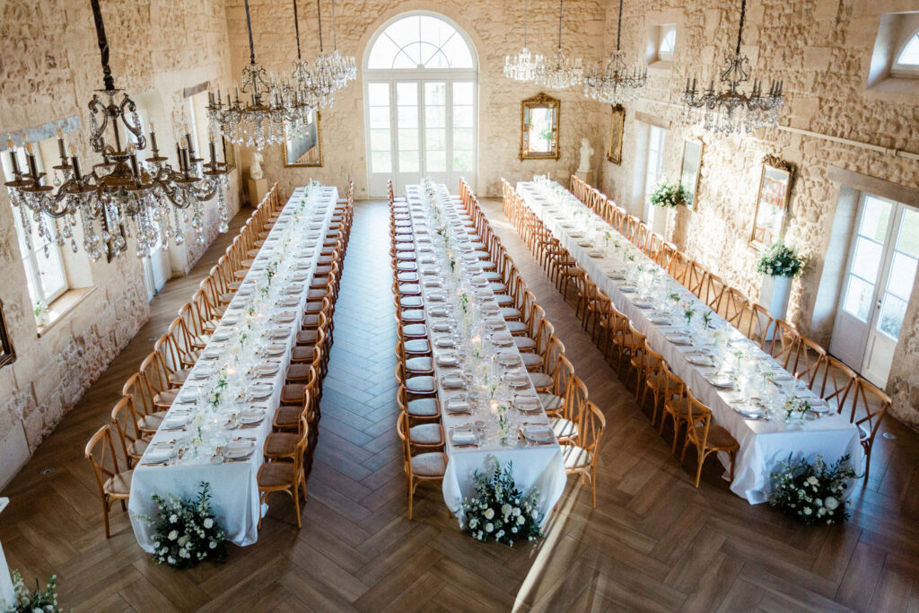 A breathtaking overhead view of the grand reception hall, set for Lauren & Richie’s wedding party in Bordeaux