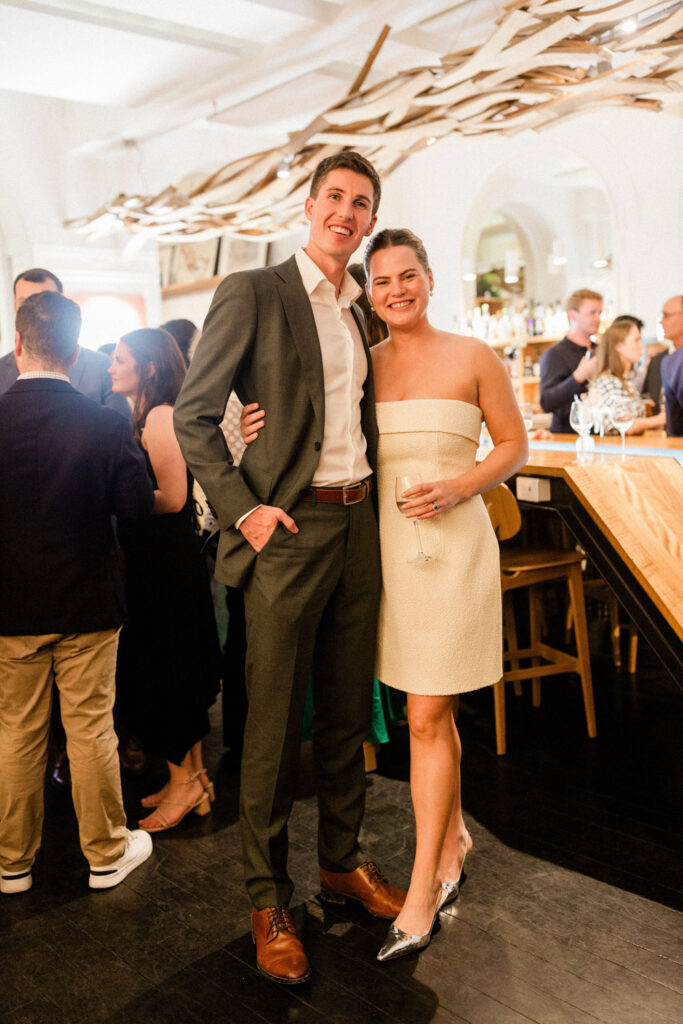 Lauren and Richie celebrating at a stylish wine bar during their dinner rehearsal for a wedding party in Bordeaux
