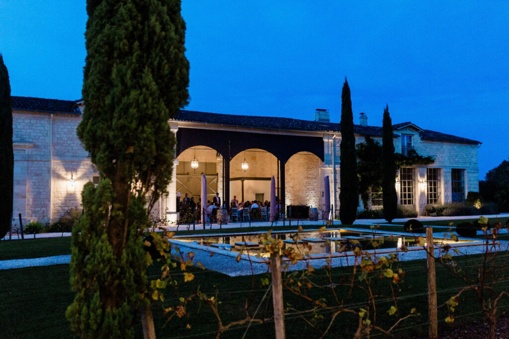 The wedding venue at night, glowing under soft lighting, reflecting its timeless elegance