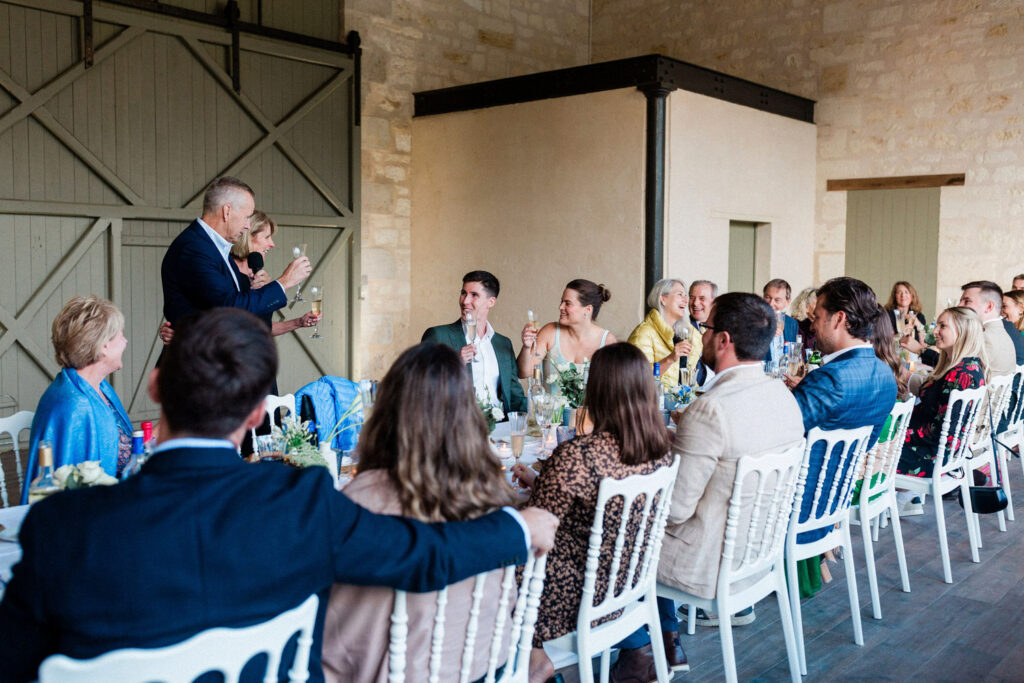 A heartfelt wedding toast during an intimate rehearsal dinner at a Bordeaux estate