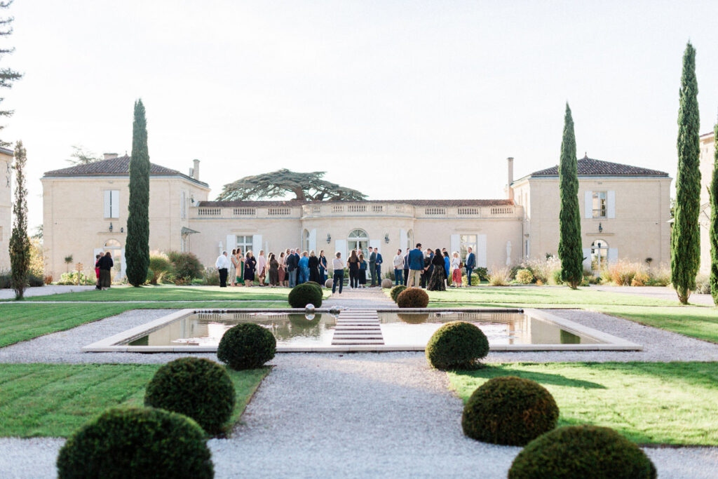 Guests gathering in the elegant courtyard of the château, soaking in the wedding ambiance