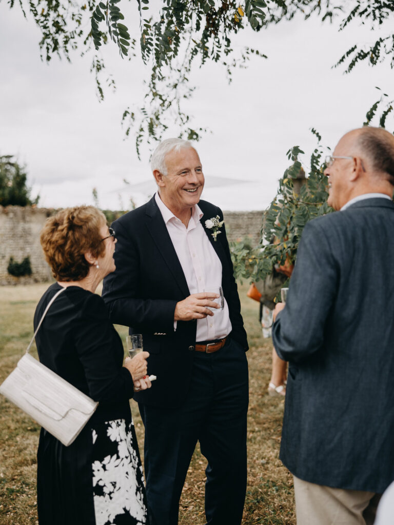 Guests enjoying drinks and conversation outdoors.