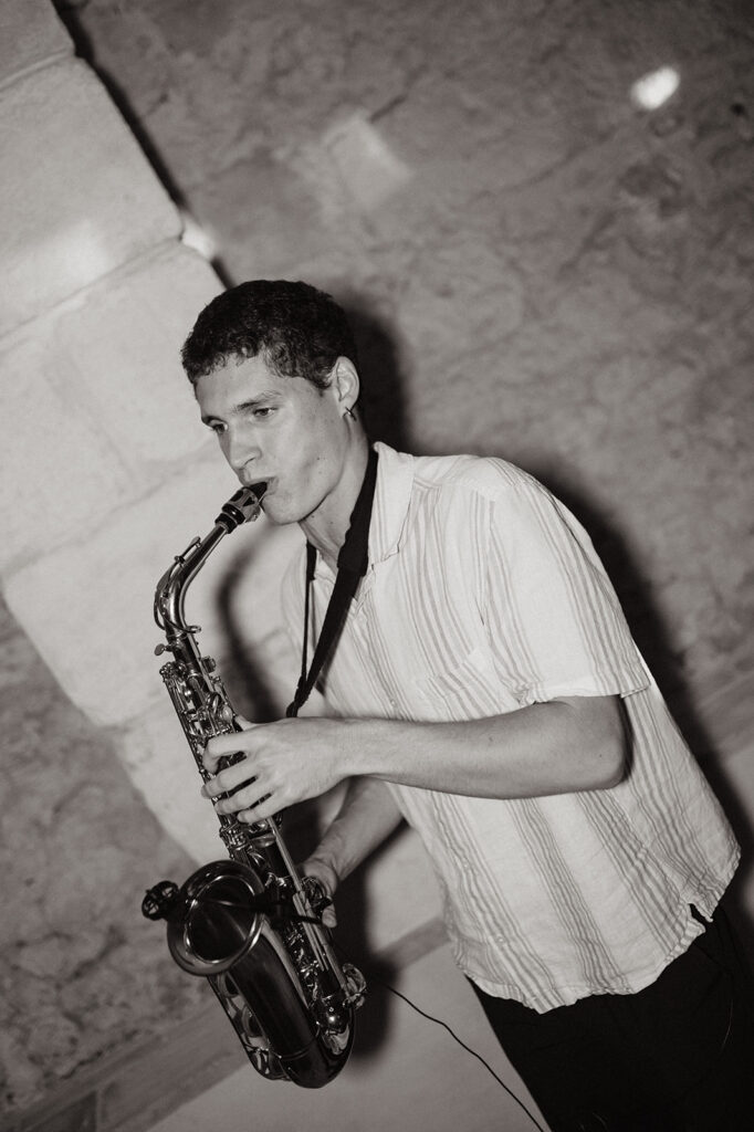 A saxophonist plays during the reception, setting a romantic tone.