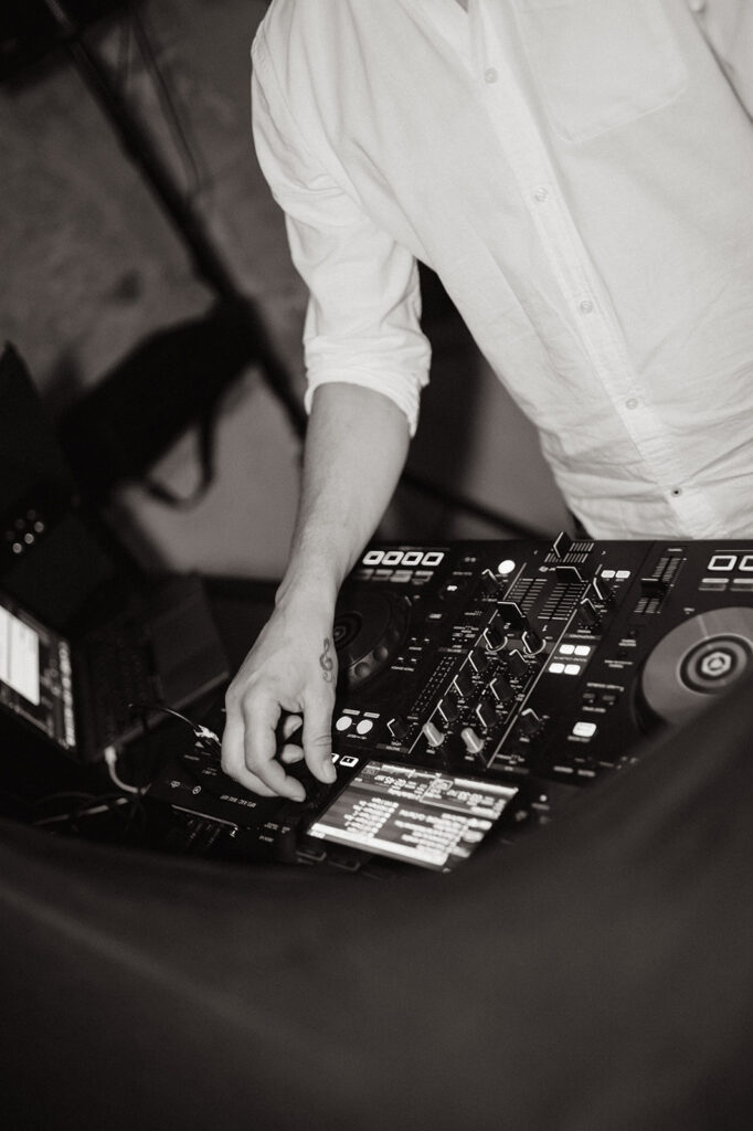 A DJ adjusts the controls mid-set during the evening celebration.