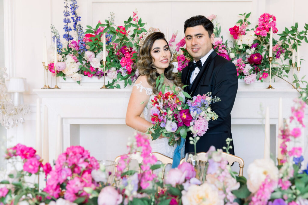  Bride and groom portrait in front of floral fireplace
