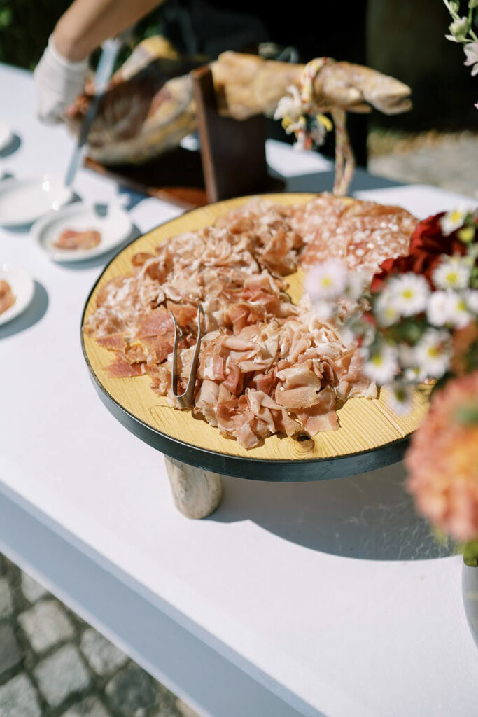 Charcuterie platter with prosciutto and salami at a destination wedding.