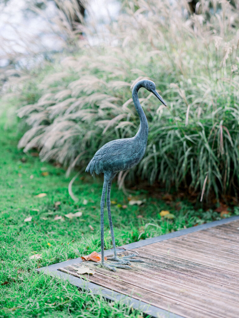 Sculpture of a crane beside wooden path at French wedding venue