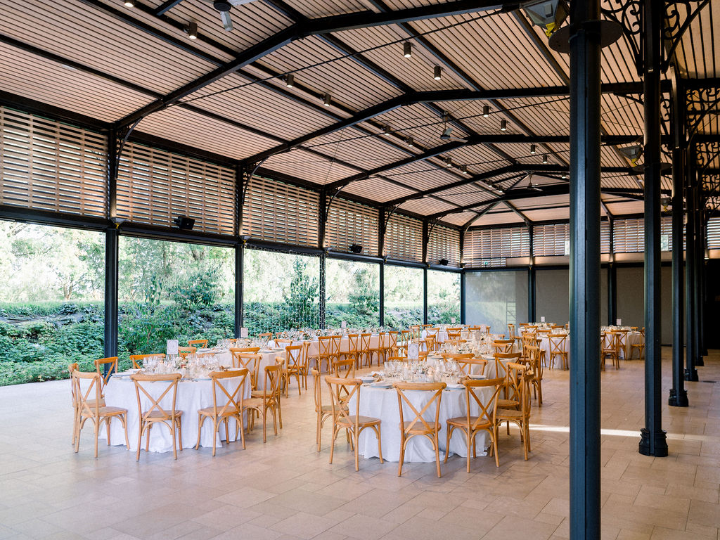 Spacious covered hall set for an elegant French wedding reception